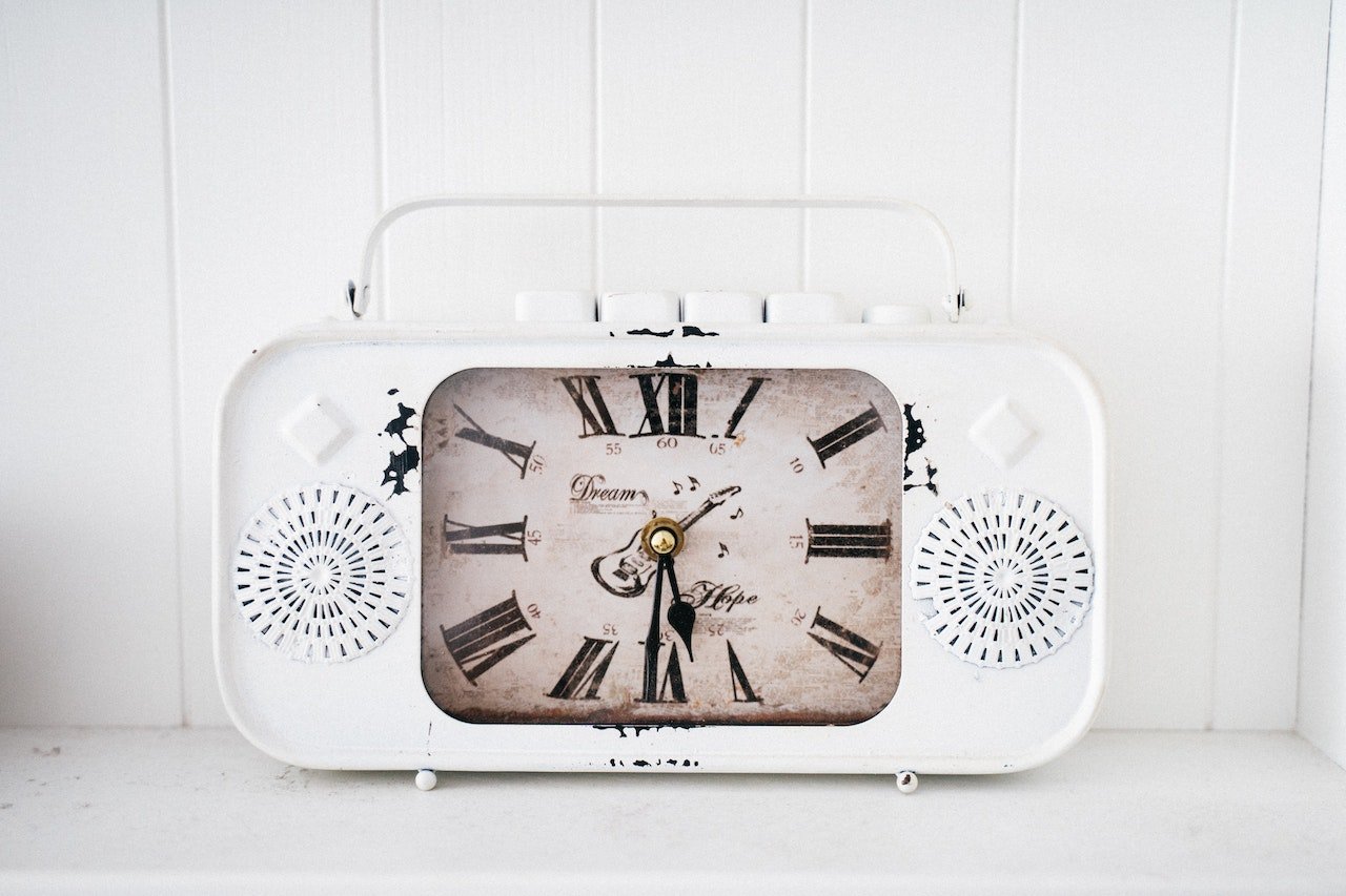 White Antique Clock On Table