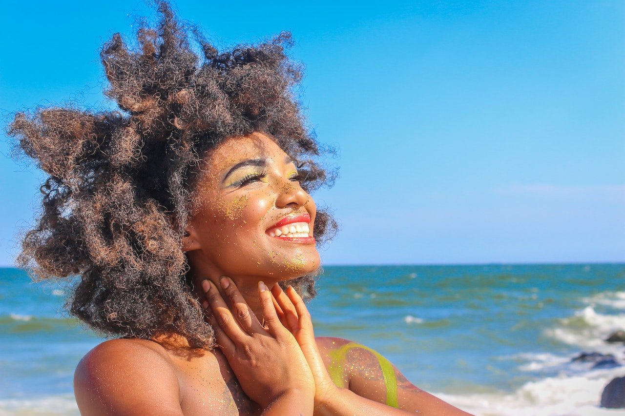 woman on the beach being happy