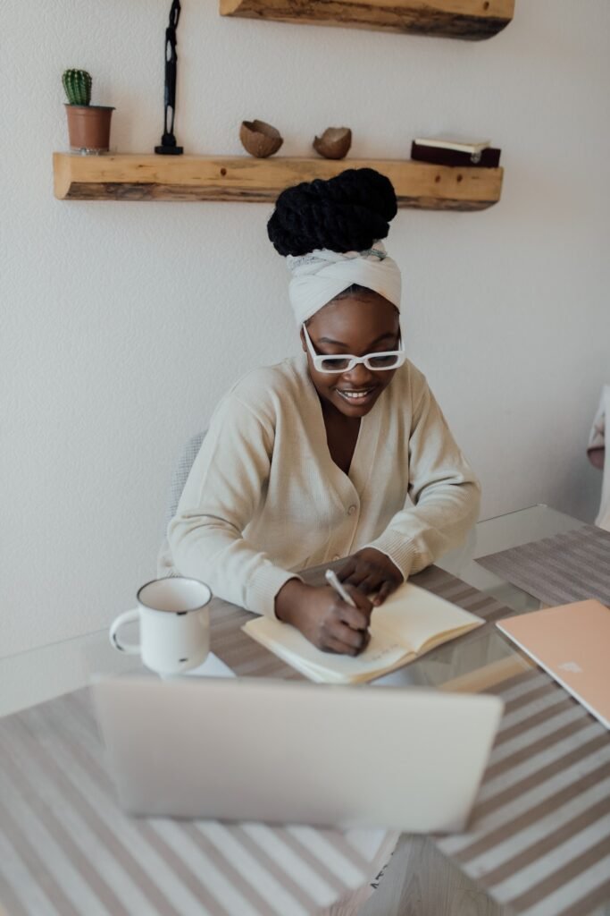 50 daily gratitude journal prompts; woman writing on journal