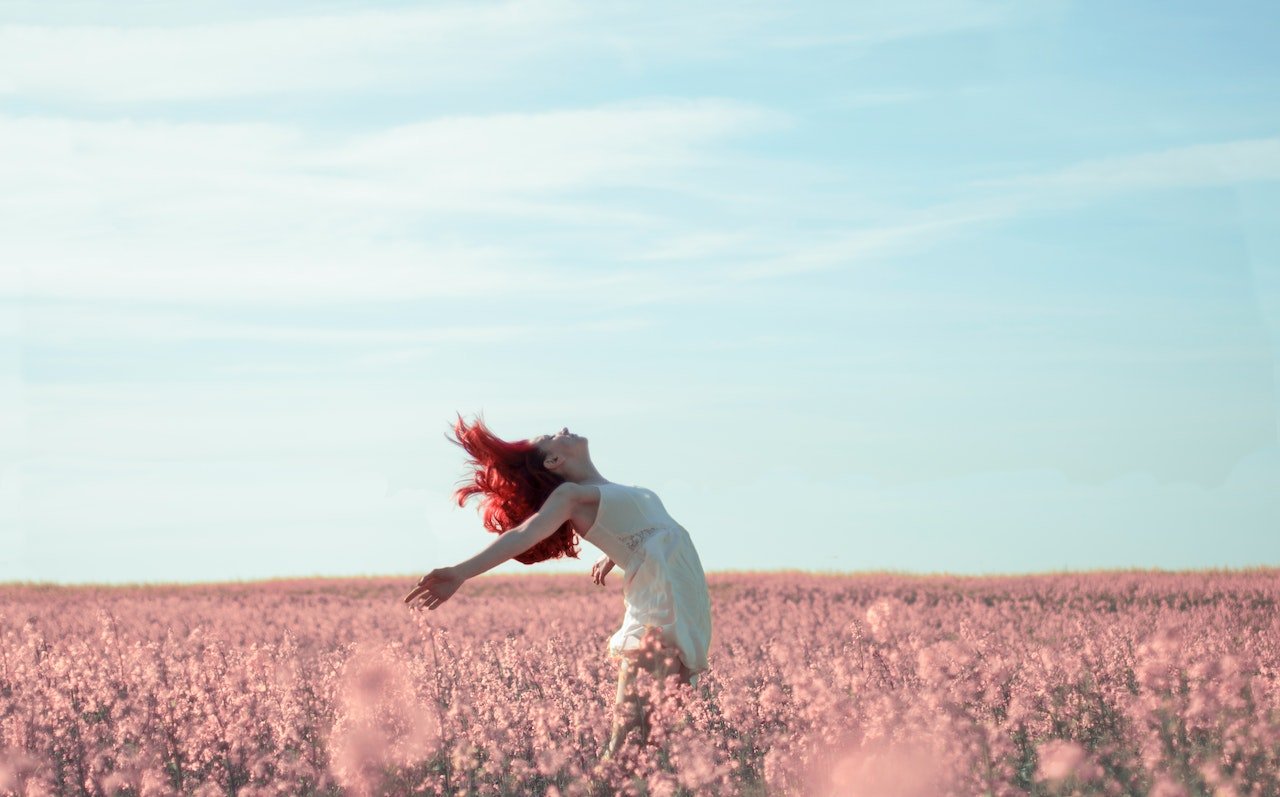 Confident and happy woman on a flower field