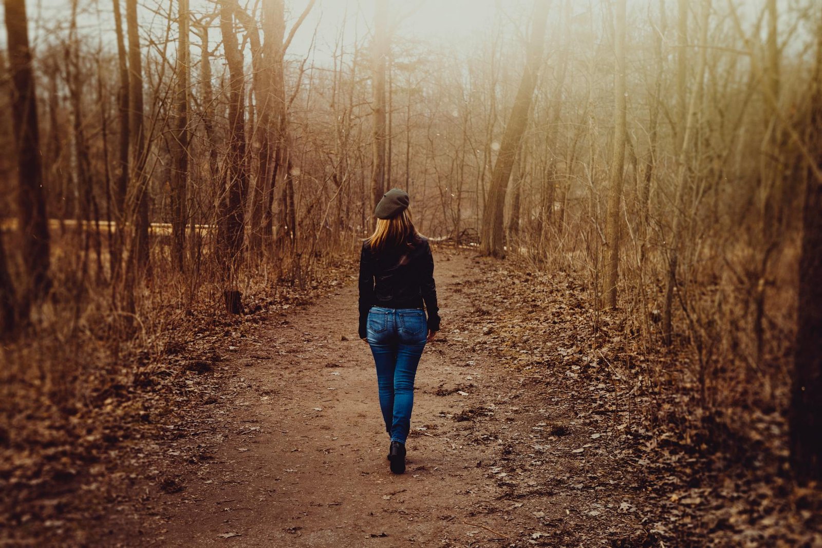 Woman walking alone in forest reptesenting quiet confidence