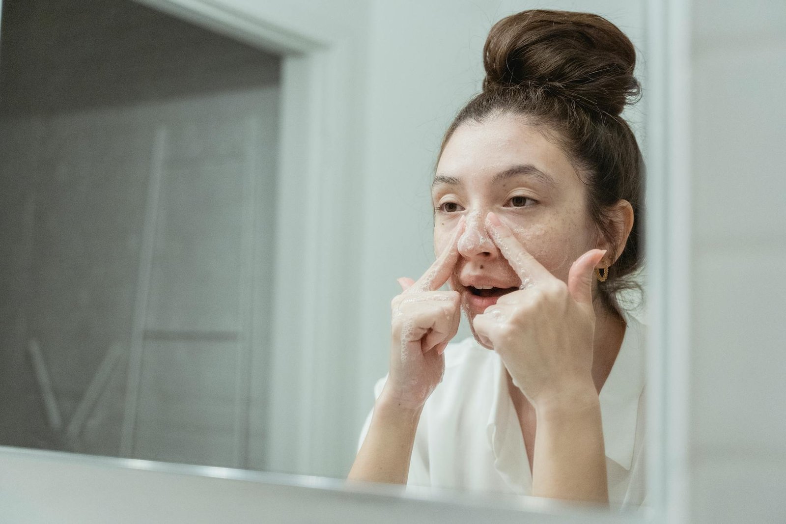 woman cleansing her face