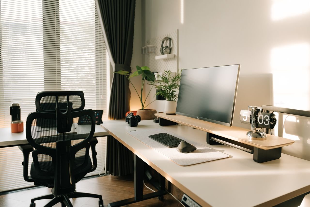 Minimalist organized home office desk with monitor and plants
