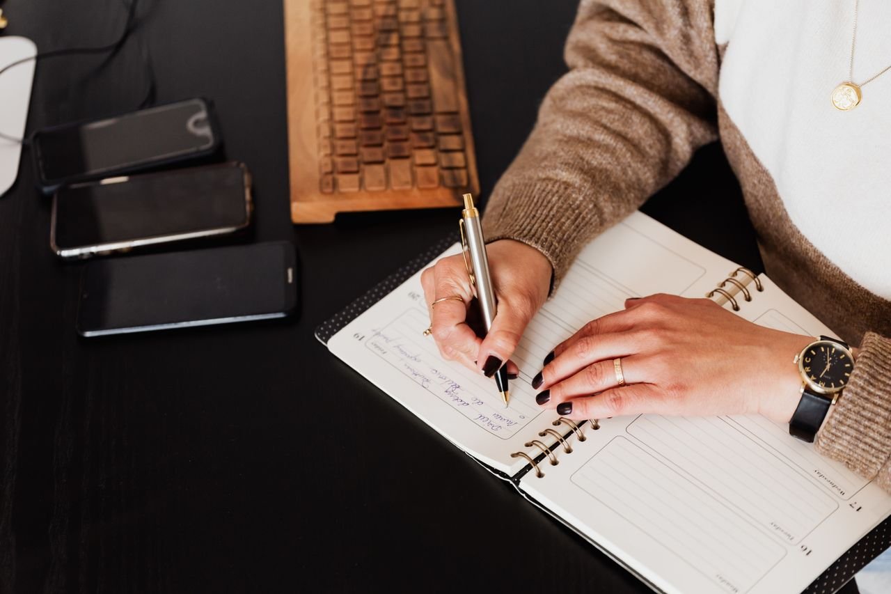 woman writing on notebook
