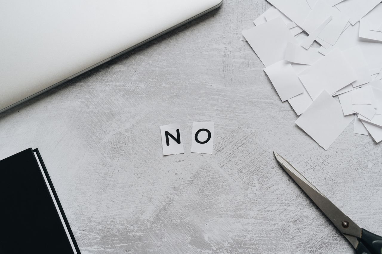 paper cut out "NO" on a desk