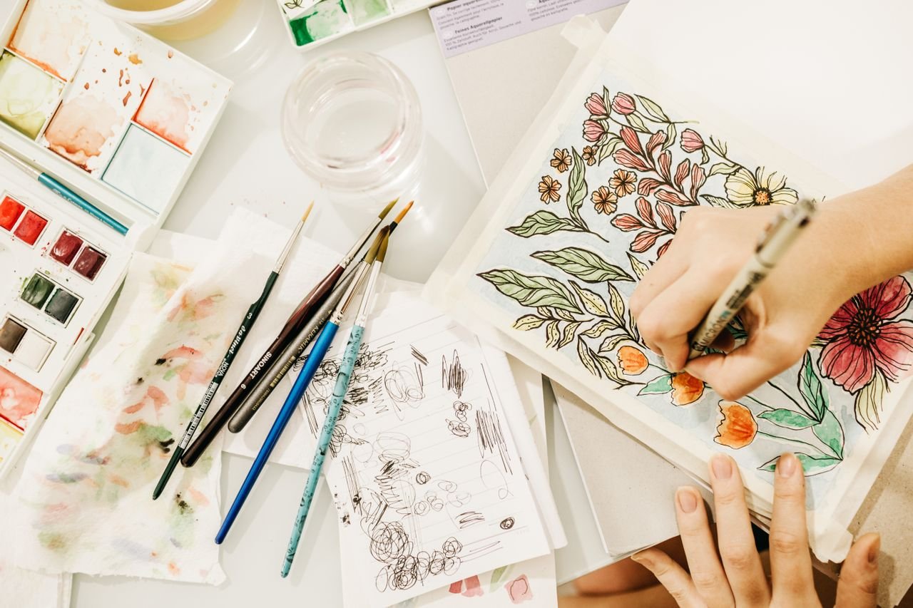 artist painting on sketchbook