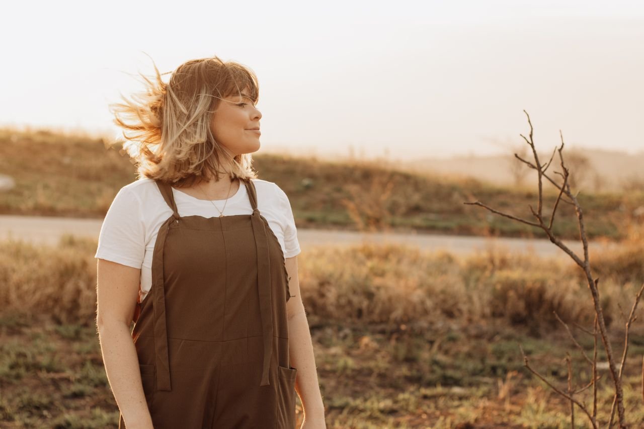 woman talking a walk and enjoying the sunset