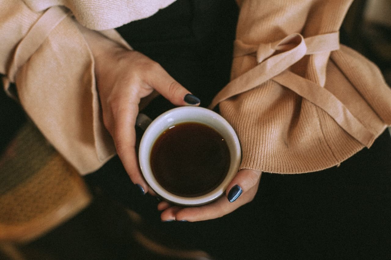 woman with cup of aromatic coffee
