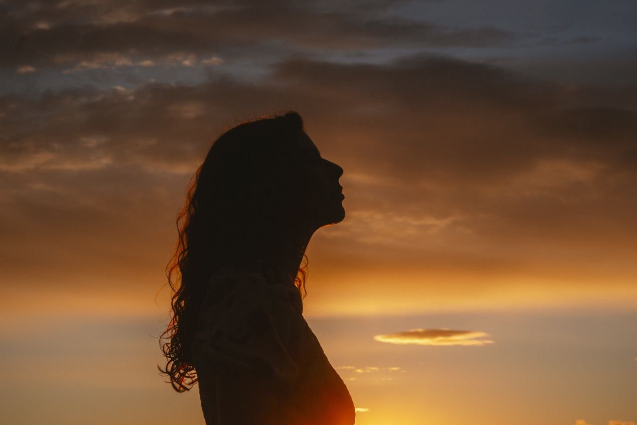 silhouette of woman at sunset