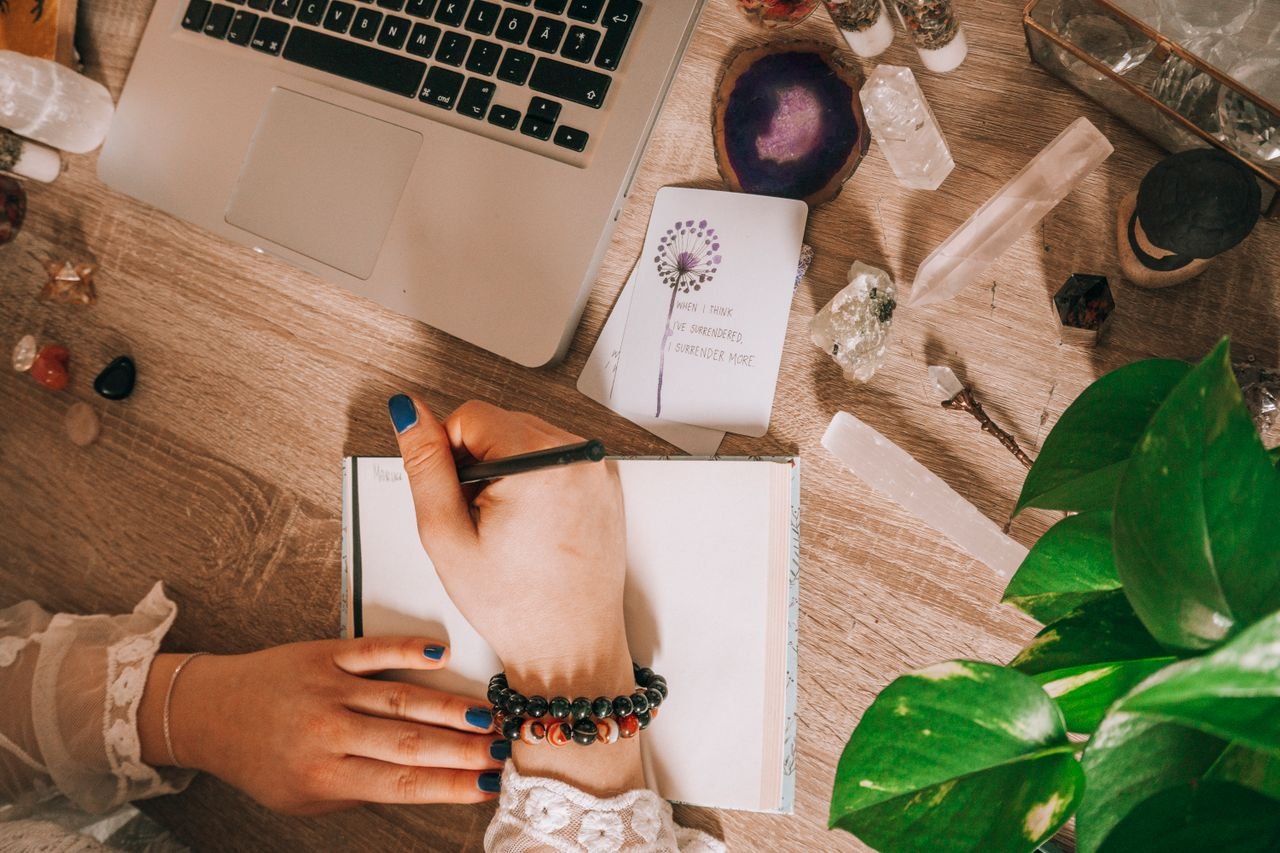 Woman writing in a notebook during a brain dump